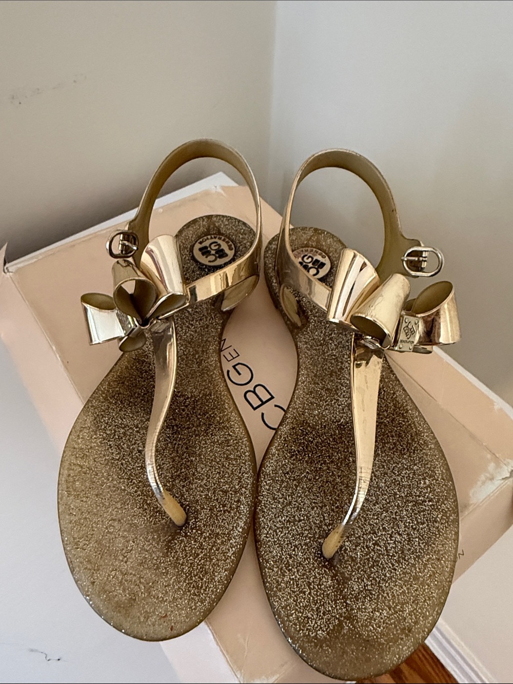 BCBGeneration Metallic Gold Bow T-Strap Jelly Sandals